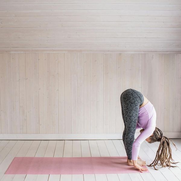 Person doing a deep forward bend, showcasing body flexibility.